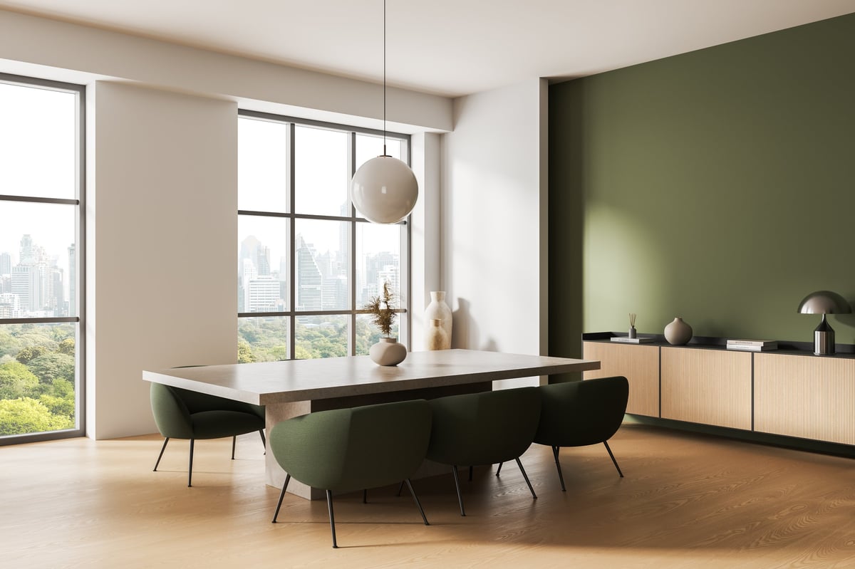 Contemporary dining interior with light wood floor, pendant light and city view through large windows in bright daylight