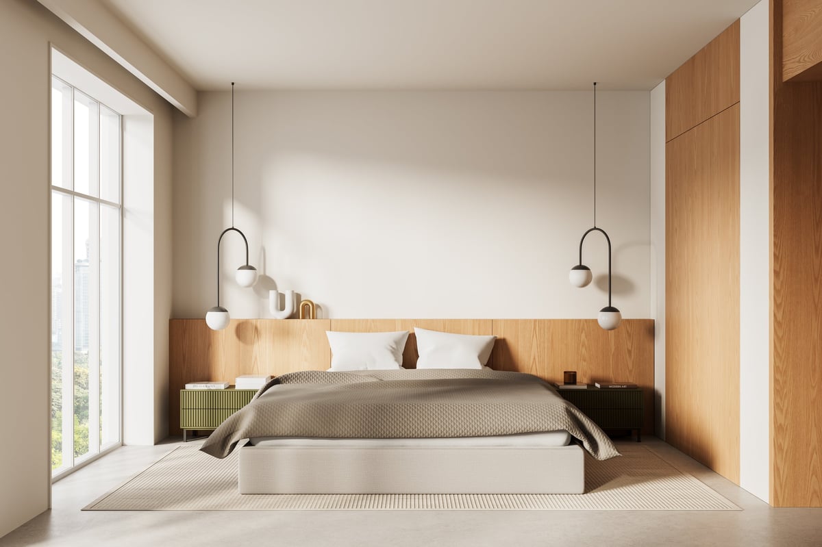 Cozy modern bedroom interior with minimal design, soft beige tones, pendant lighting, wood accents and large window